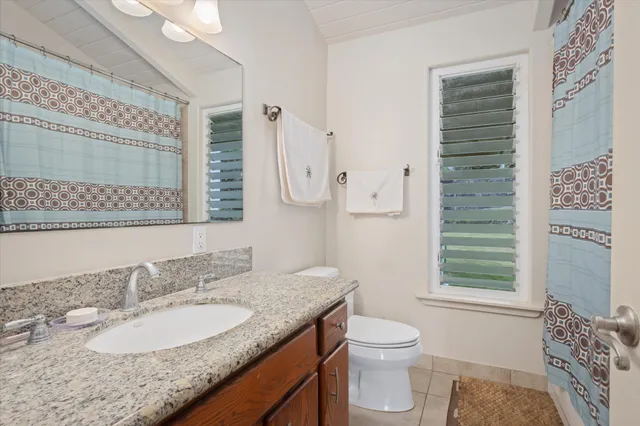 a living room with furniture a flat screen tv and a large window