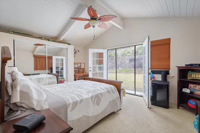 a bedroom with bed and a chandelier