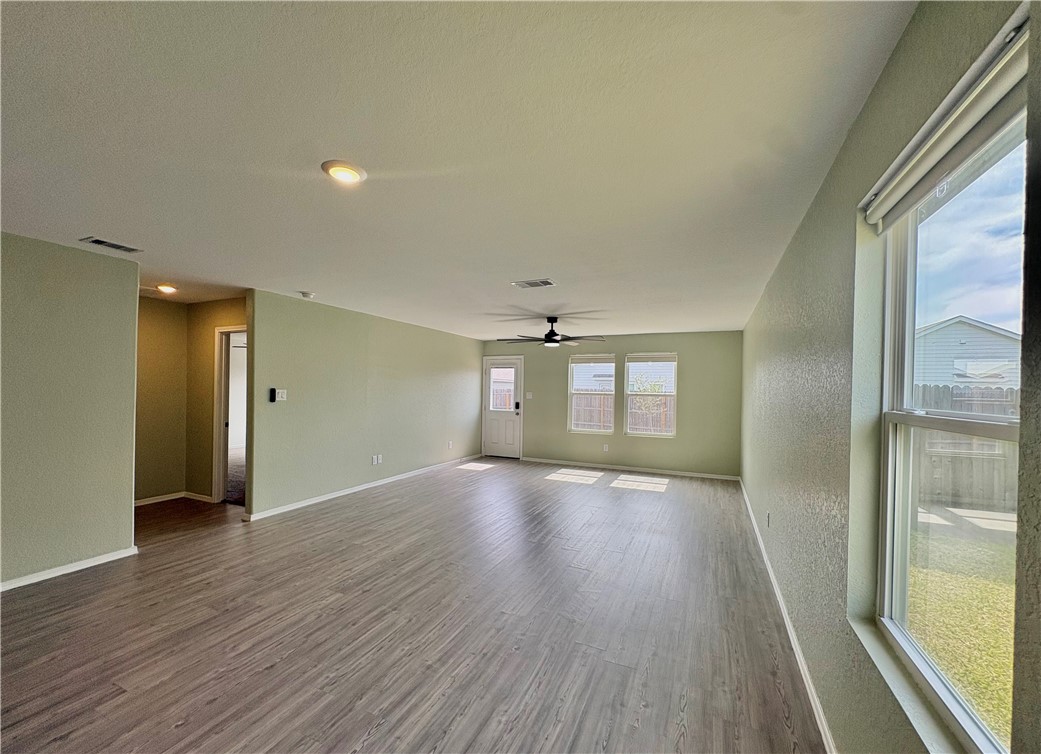 1109 Demeter Drive Portland, TX 78374 - Photo 6 of 18 wooden floor in an empty room with a window