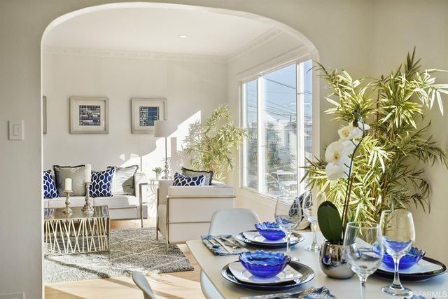 a bedroom with a bed and a lamp on dresser