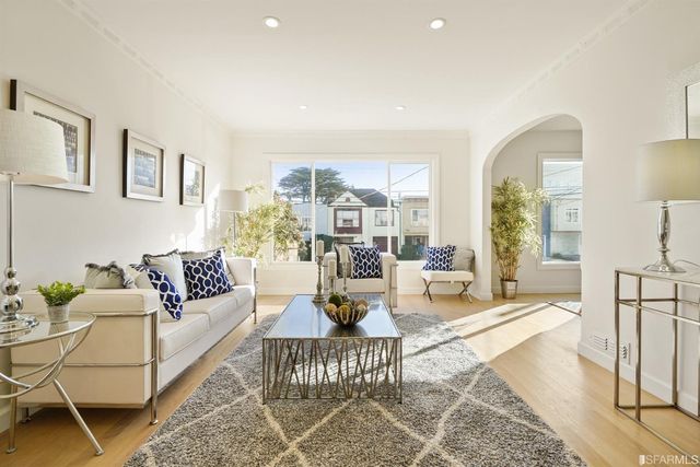 a bedroom with a bed and a mirror on the dresser