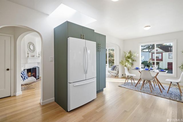 a dining room with furniture and wooden floor