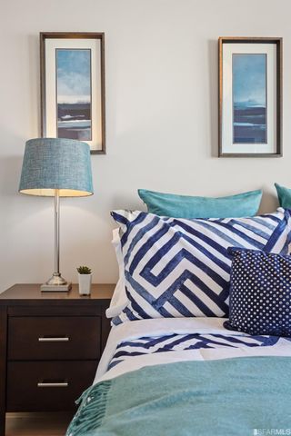 a view of a patio with couches table and chairs with wooden floor and fence