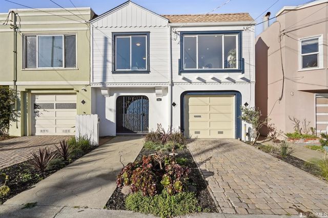 a living room with furniture and a lamp