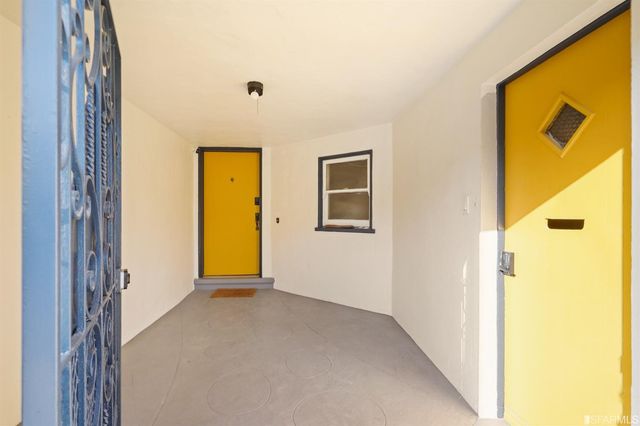 a living room with fireplace furniture and a floor to ceiling window