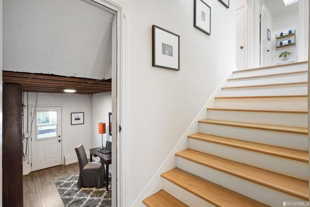 a bedroom with a bed and a lamp on dresser