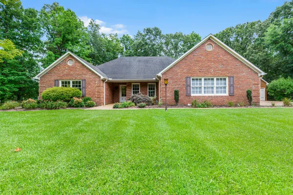 a front view of house with yard and green space