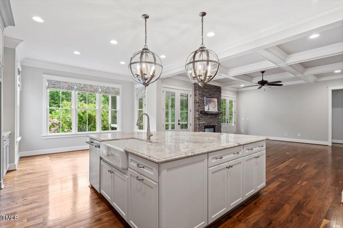 612 Hawks Ridge Court Apex, NC 27539 - Photo 11 of 58 a kitchen with stainless steel appliances granite countertop a sink dishwasher a stove and a wooden floor