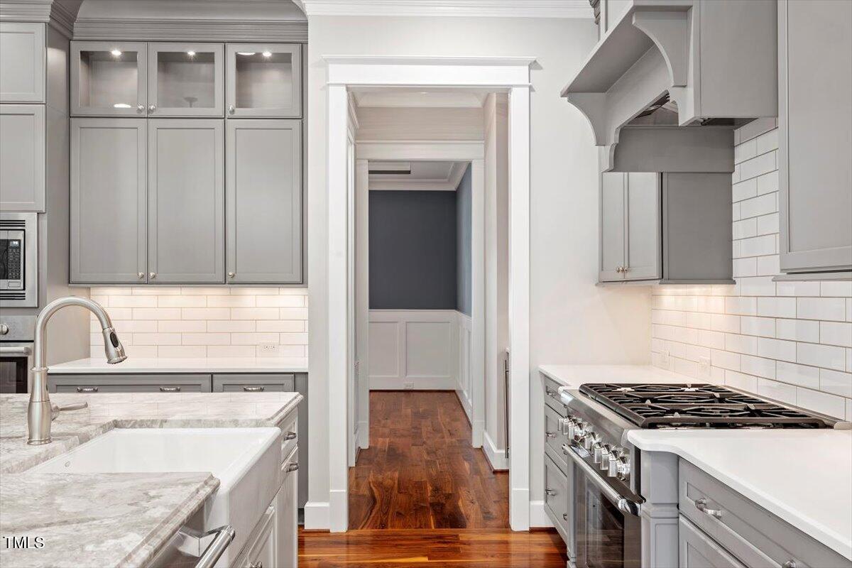 612 Hawks Ridge Court Apex, NC 27539 - Photo 12 of 58 a kitchen with granite countertop a sink stove and cabinets