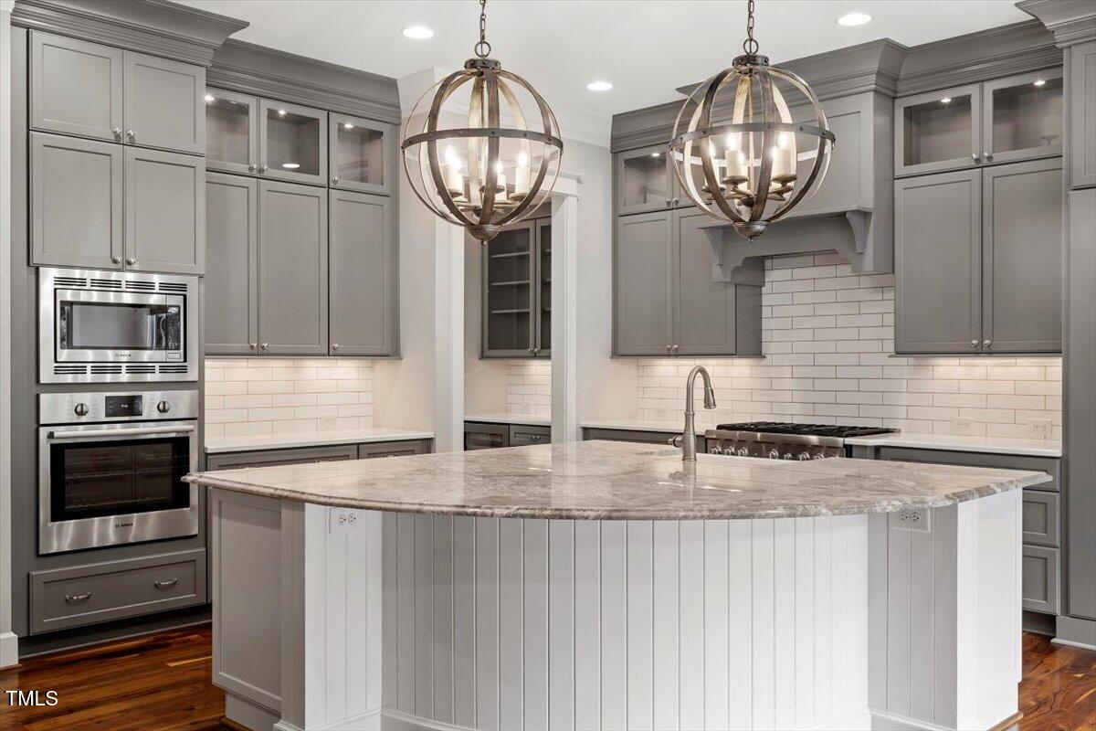 612 Hawks Ridge Court Apex, NC 27539 - Photo 14 of 58 a kitchen with stainless steel appliances granite countertop a sink and cabinets