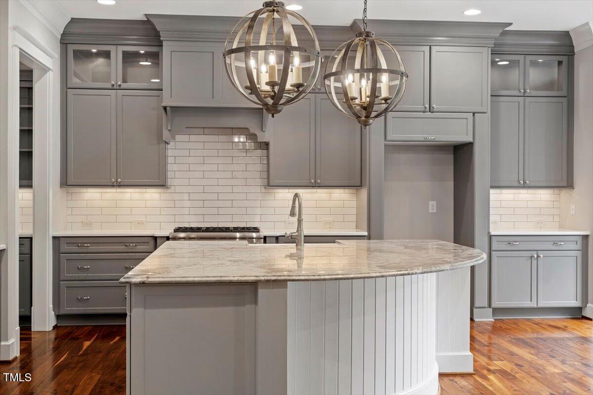 612 Hawks Ridge Court Apex, NC 27539 - Photo 16 of 58 a kitchen with stainless steel appliances granite countertop a sink refrigerator and cabinets