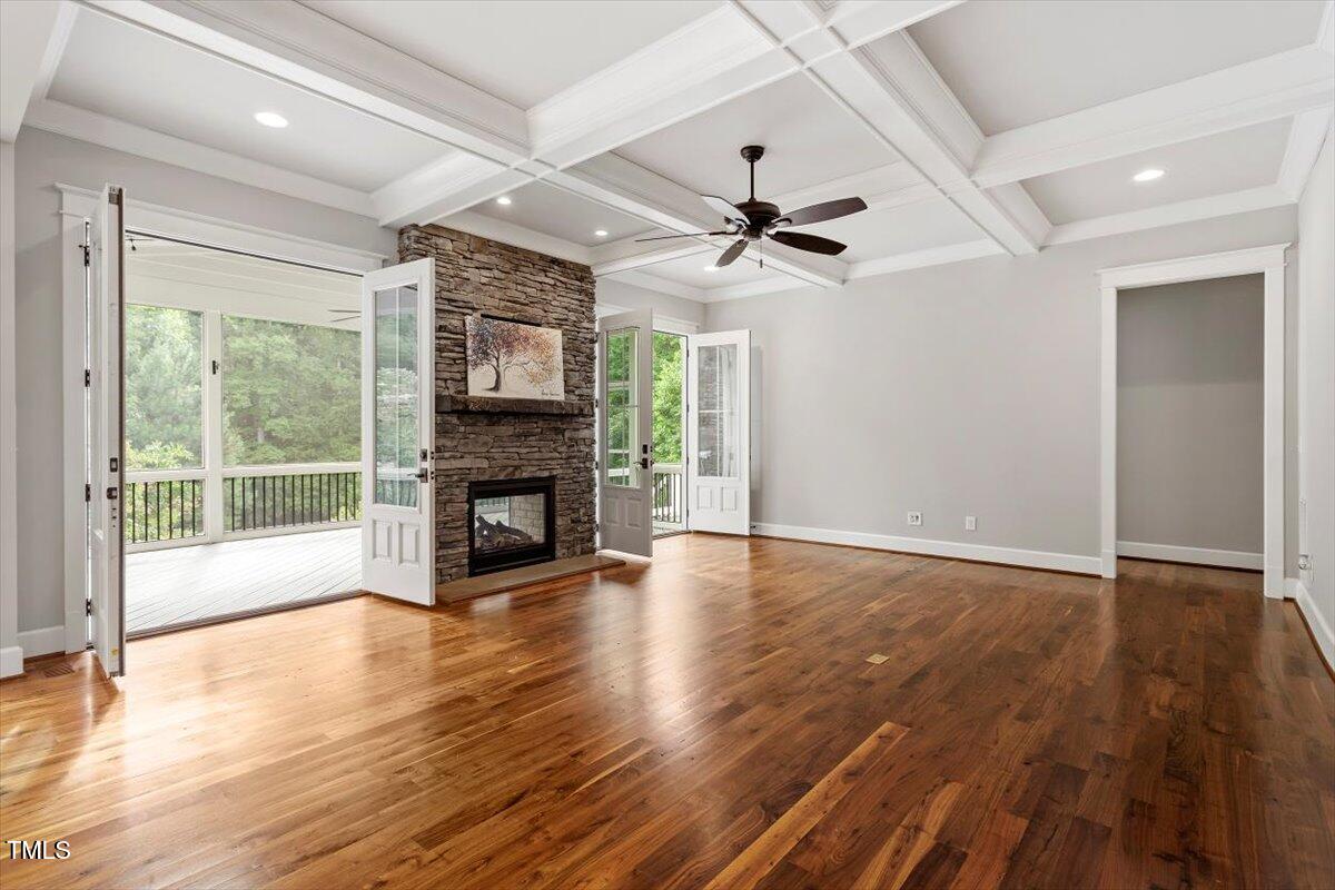 612 Hawks Ridge Court Apex, NC 27539 - Photo 20 of 58 a view of an empty room with wooden floor fireplace and a window