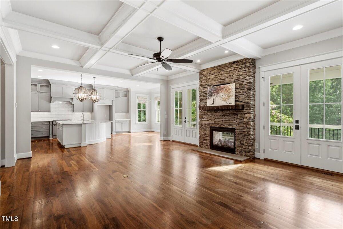 612 Hawks Ridge Court Apex, NC 27539 - Photo 21 of 58 a view of a livingroom with fireplace wooden floor and a ceiling fan