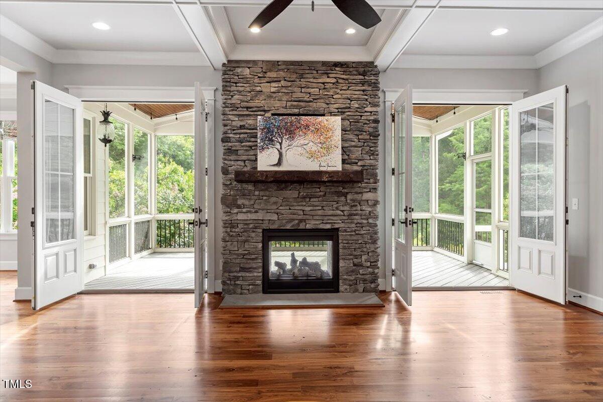 612 Hawks Ridge Court Apex, NC 27539 - Photo 22 of 58 a living room with a fireplace and wooden floor