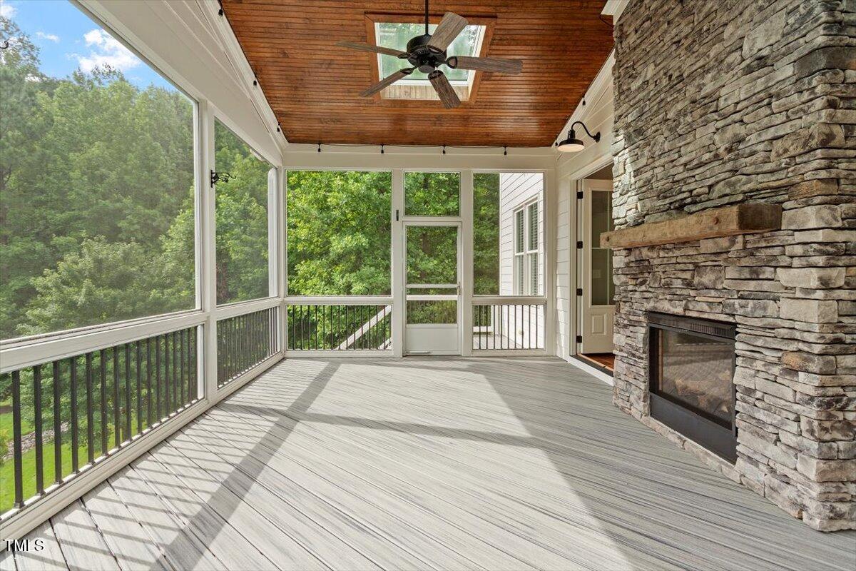 612 Hawks Ridge Court Apex, NC 27539 - Photo 23 of 58 a view of a porch with wooden floor and a fireplace