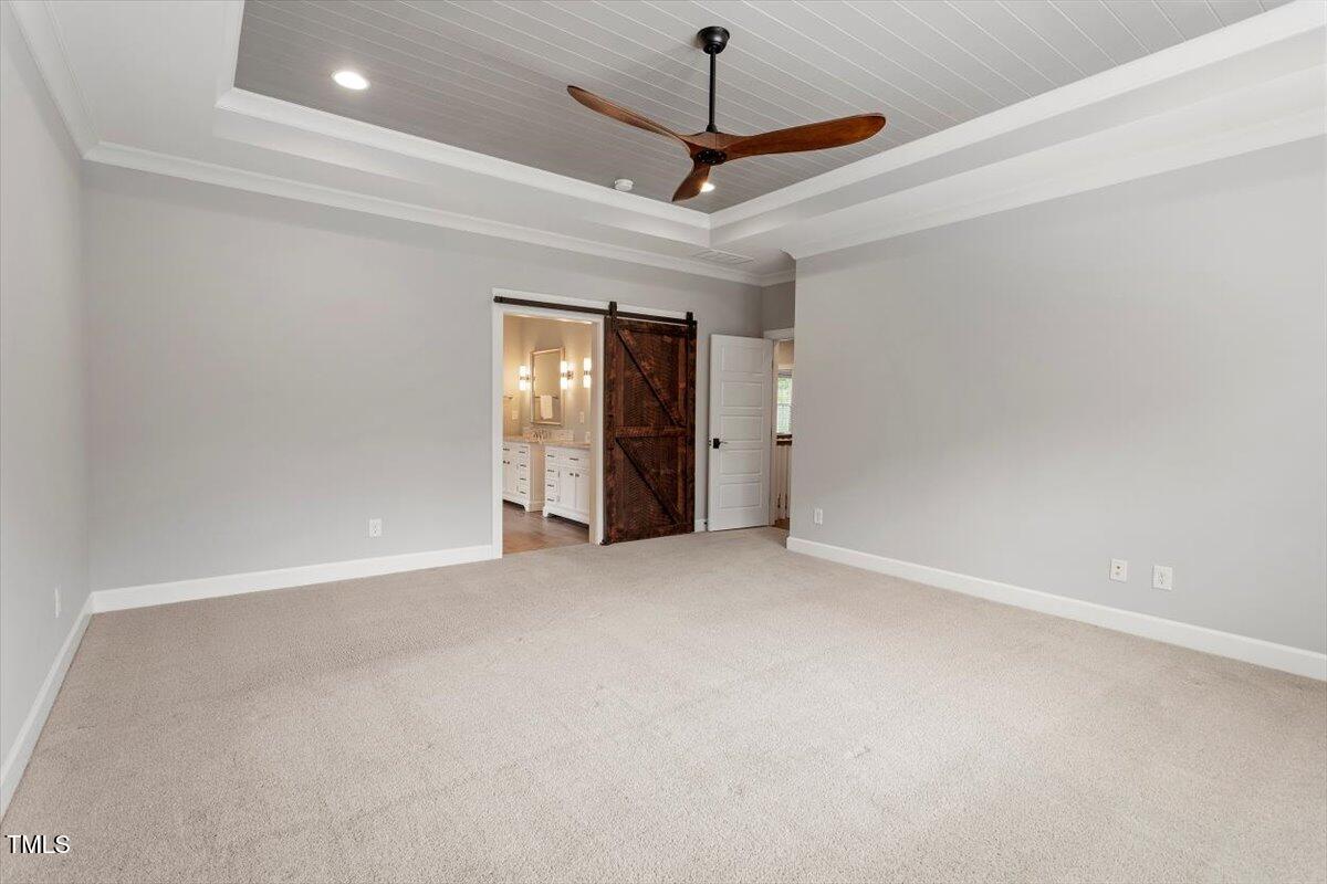 612 Hawks Ridge Court Apex, NC 27539 - Photo 26 of 58 a view of an empty room with a chandelier fan