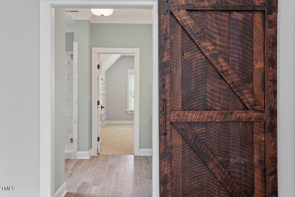 612 Hawks Ridge Court Apex, NC 27539 - Photo 27 of 58 a view of hallway with wooden floor