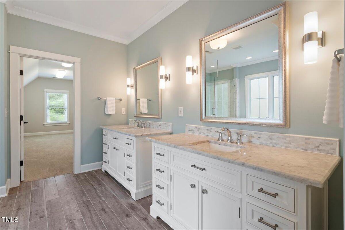 612 Hawks Ridge Court Apex, NC 27539 - Photo 28 of 58 a bathroom with a granite countertop double vanity sink mirror and
