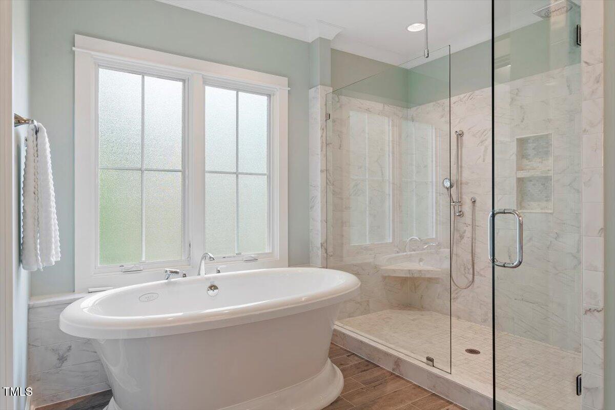 612 Hawks Ridge Court Apex, NC 27539 - Photo 29 of 58 a white bath tub sitting next to a shower