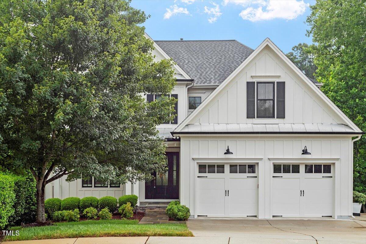 612 Hawks Ridge Court Apex, NC 27539 - Photo 3 of 58 a view of a big house with garden and trees