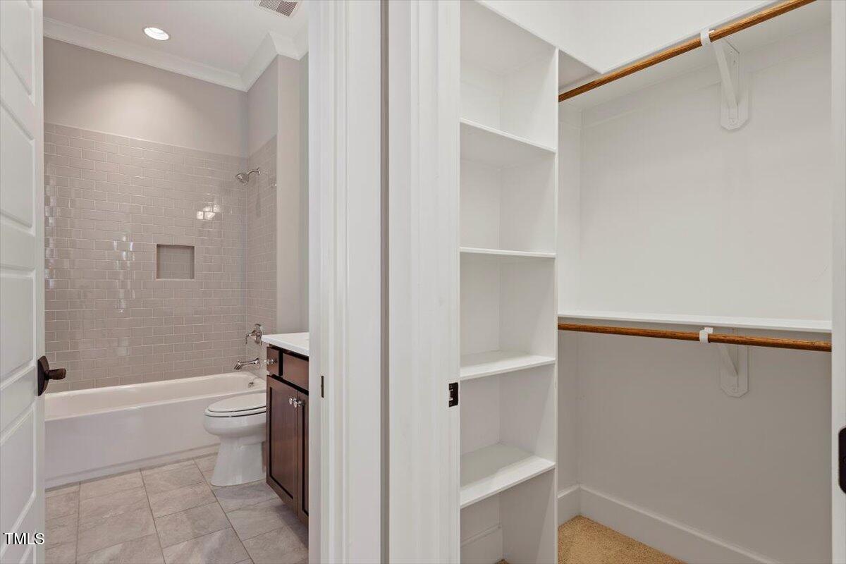 612 Hawks Ridge Court Apex, NC 27539 - Photo 34 of 58 a bathroom with a shower and a toilet