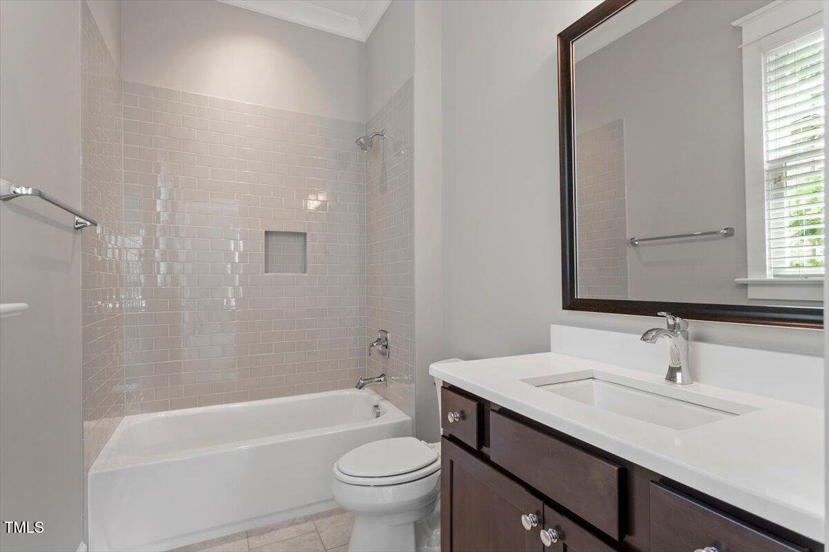 612 Hawks Ridge Court Apex, NC 27539 - Photo 35 of 58 a bathroom with a granite countertop sink a toilet and bathtub