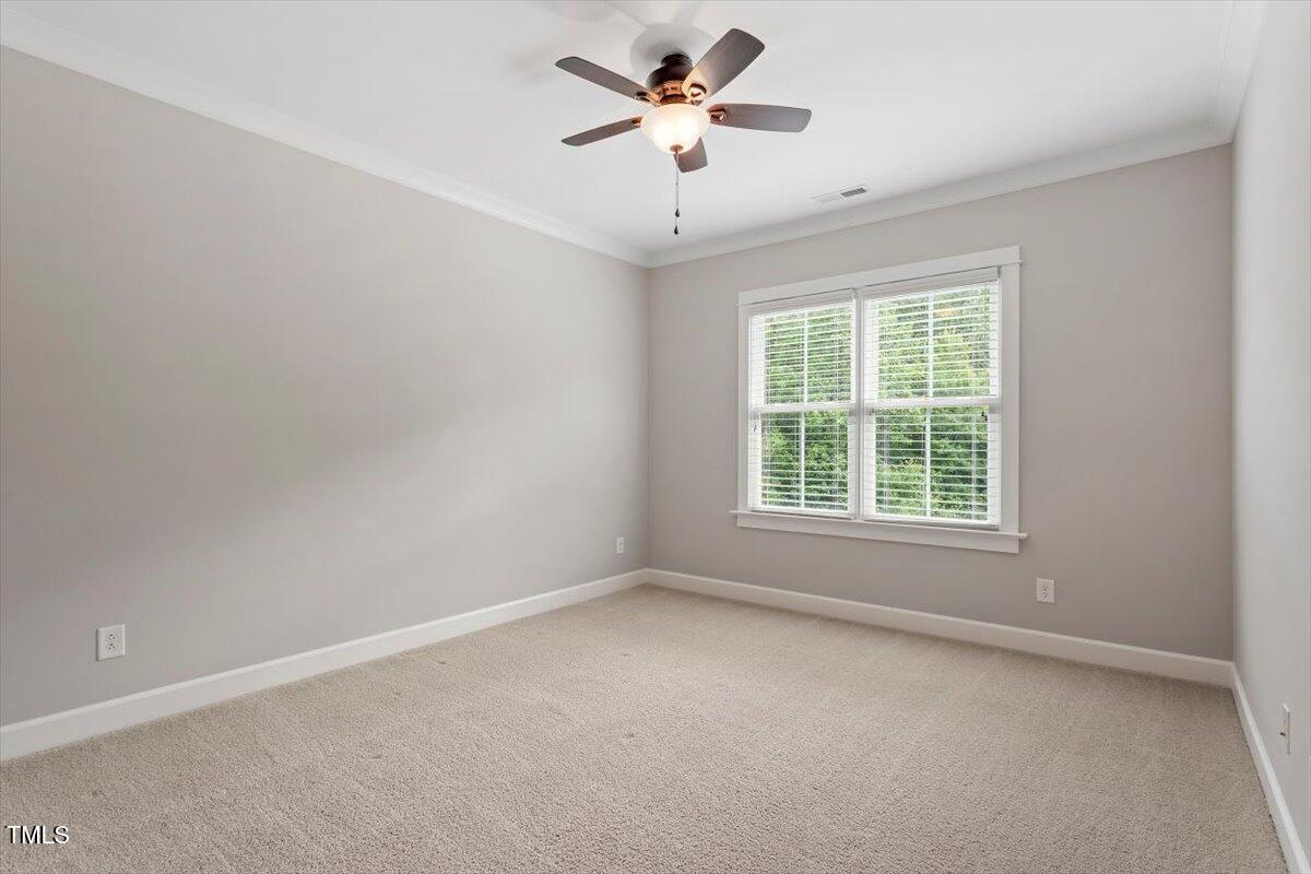 612 Hawks Ridge Court Apex, NC 27539 - Photo 42 of 58 an empty room with a window and a ceiling fan