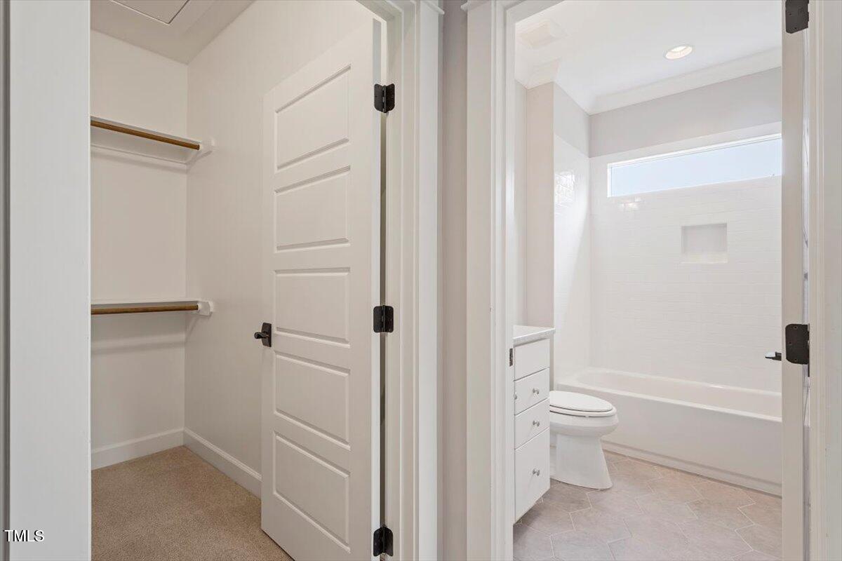 612 Hawks Ridge Court Apex, NC 27539 - Photo 43 of 58 a bathroom with a bathtub and a shower