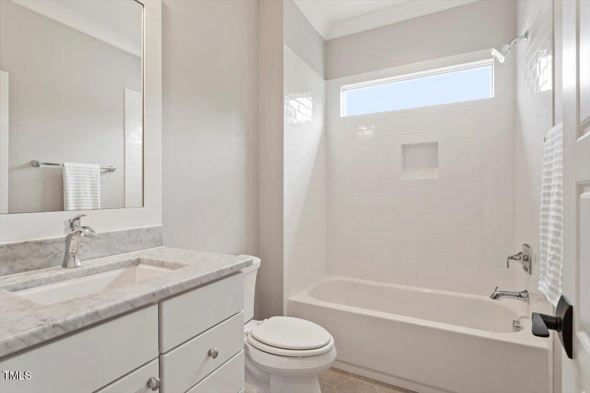 612 Hawks Ridge Court Apex, NC 27539 - Photo 44 of 58 a bathroom with a granite countertop sink a toilet and shower