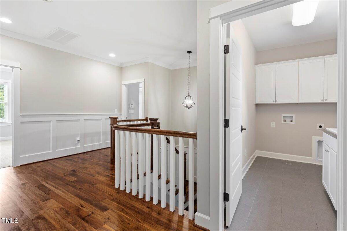 612 Hawks Ridge Court Apex, NC 27539 - Photo 45 of 58 a view of a hallway with wooden floor and staircase