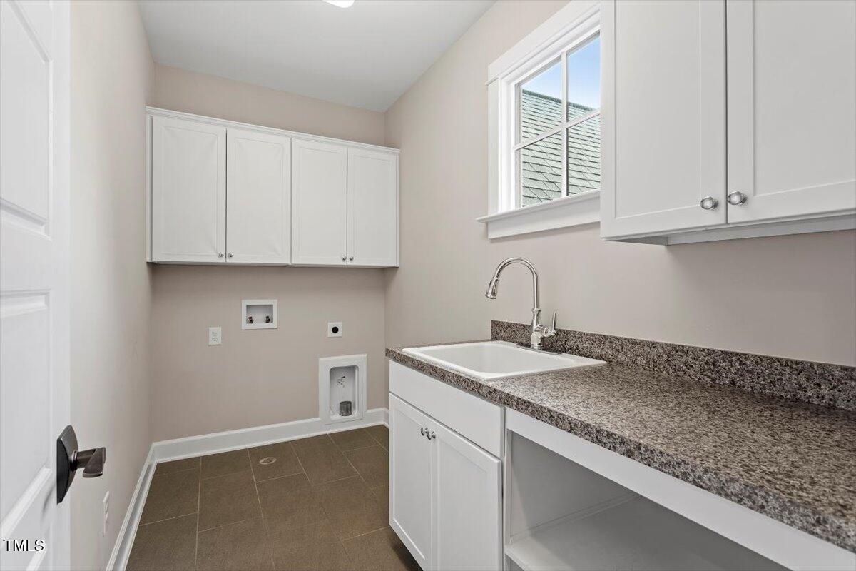 612 Hawks Ridge Court Apex, NC 27539 - Photo 46 of 58 a kitchen with granite countertop white cabinets and a sink