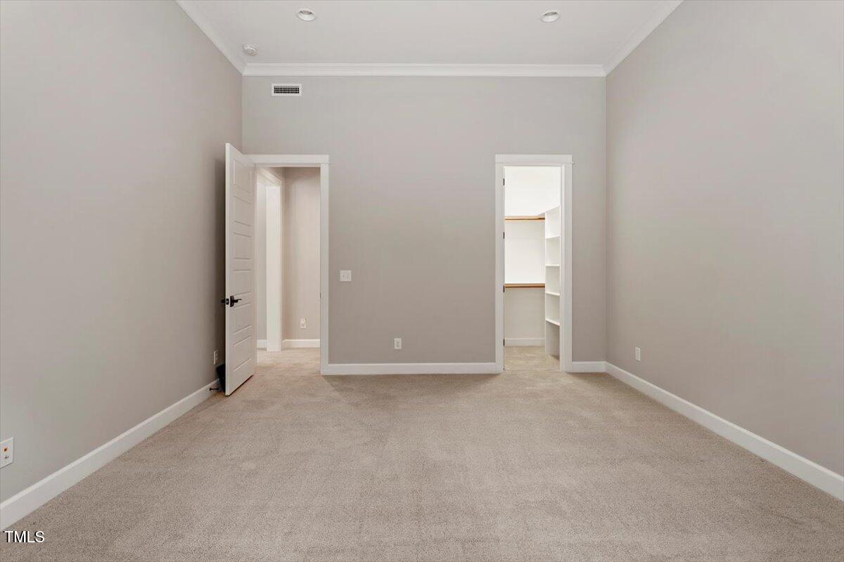 612 Hawks Ridge Court Apex, NC 27539 - Photo 53 of 58 a view of an empty room with closet and a window