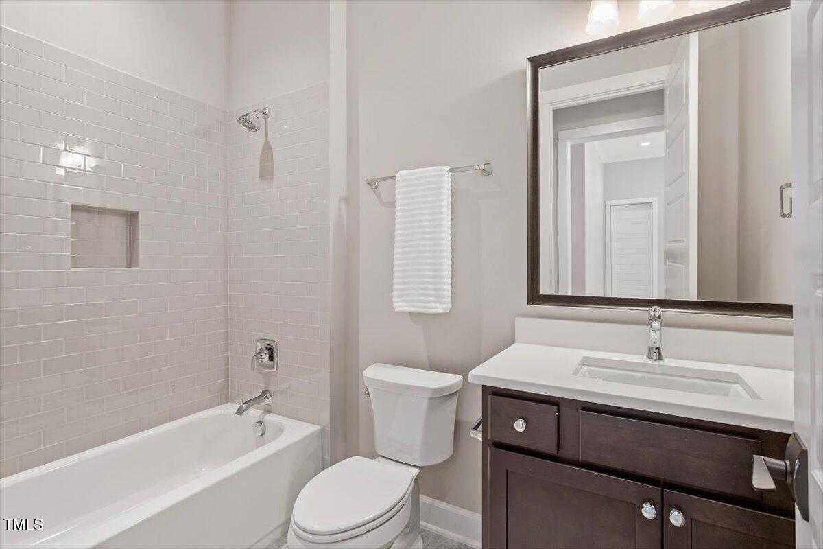 612 Hawks Ridge Court Apex, NC 27539 - Photo 54 of 58 a bathroom with a sink a toilet and shower