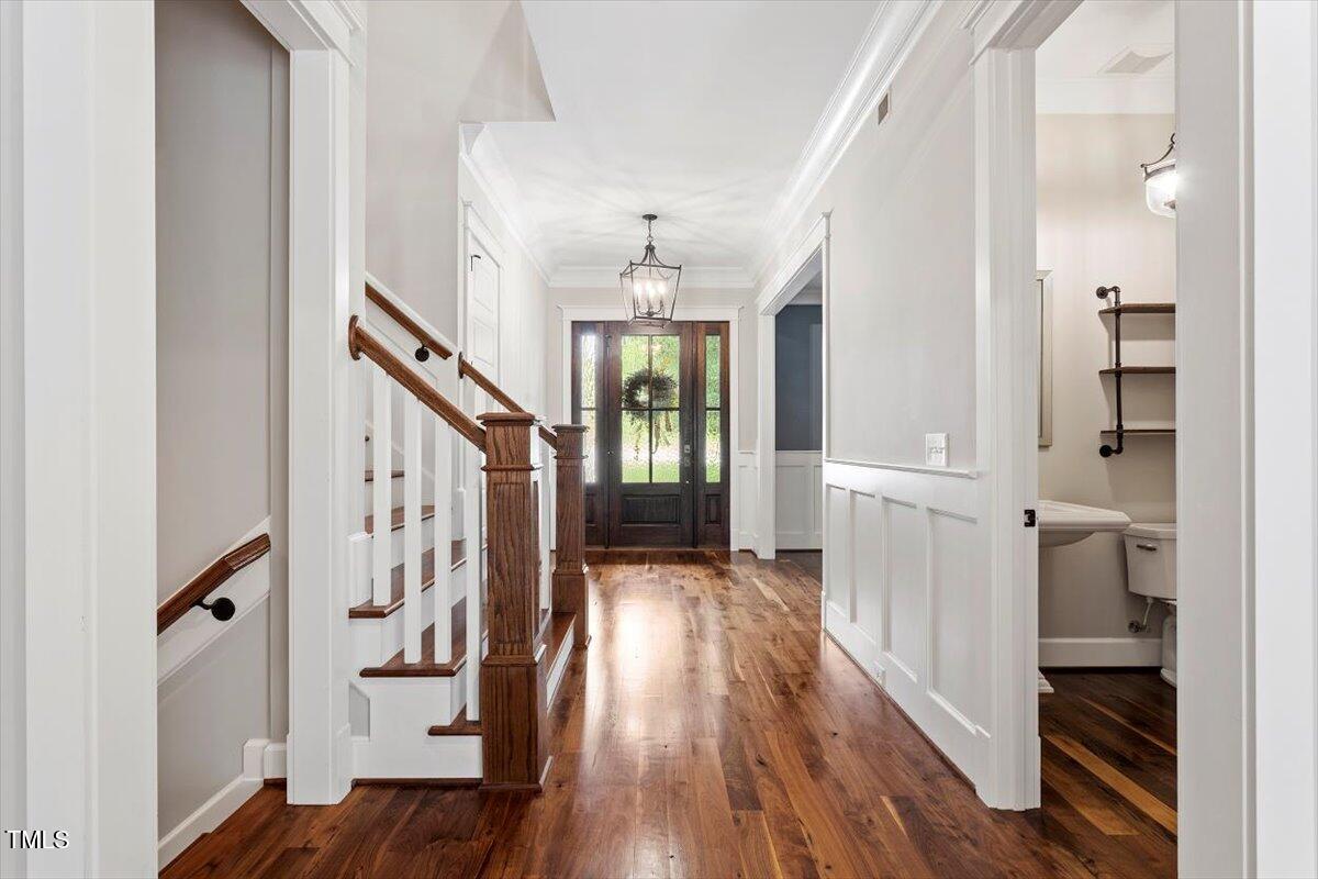 612 Hawks Ridge Court Apex, NC 27539 - Photo 6 of 58 a view of entryway with wooden floor and stair