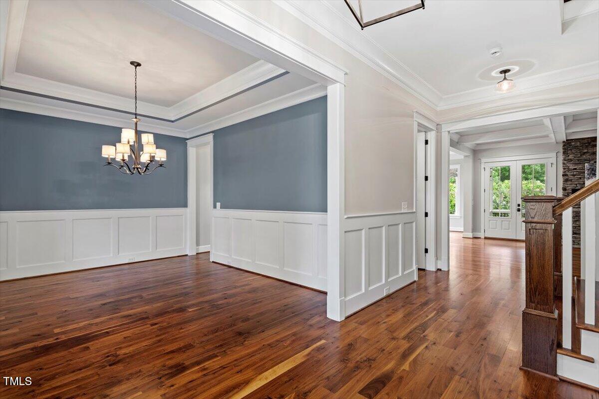 612 Hawks Ridge Court Apex, NC 27539 - Photo 8 of 58 a view of a livingroom with wooden floor stairs and a chandelier
