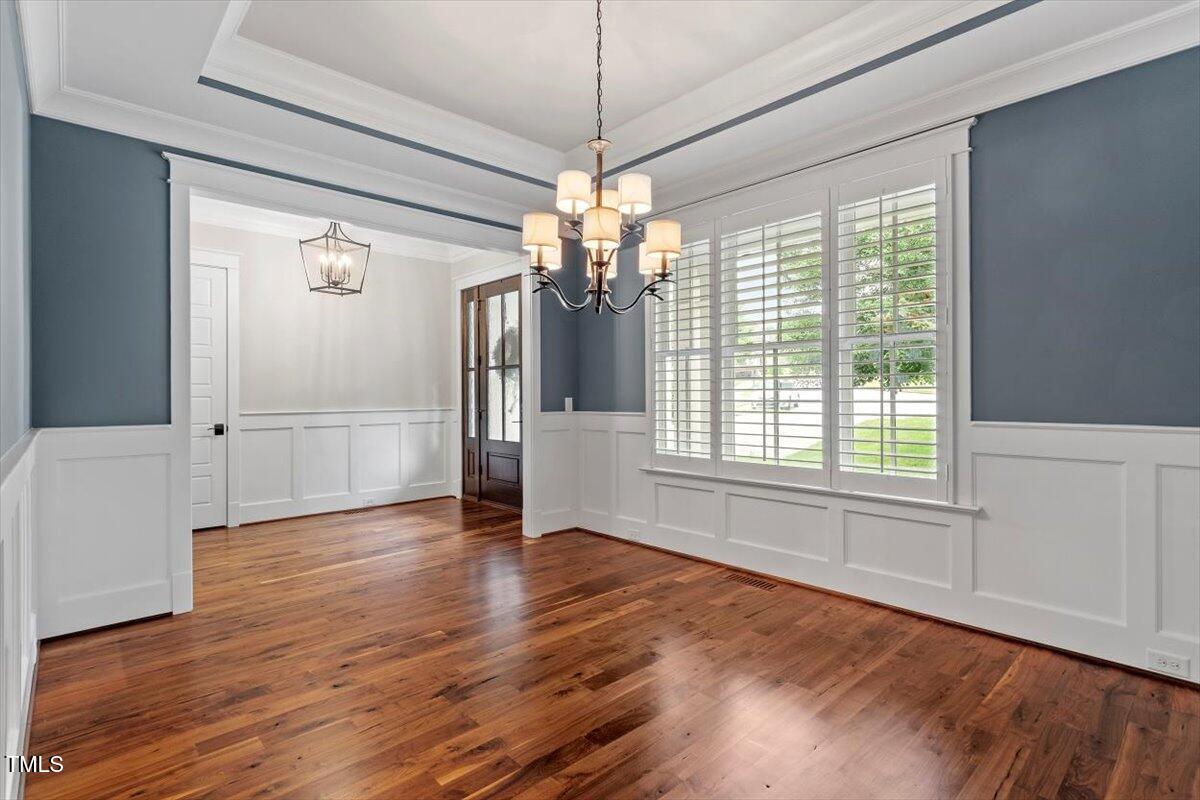 612 Hawks Ridge Court Apex, NC 27539 - Photo 10 of 58 a view of an empty room with wooden floor and a window