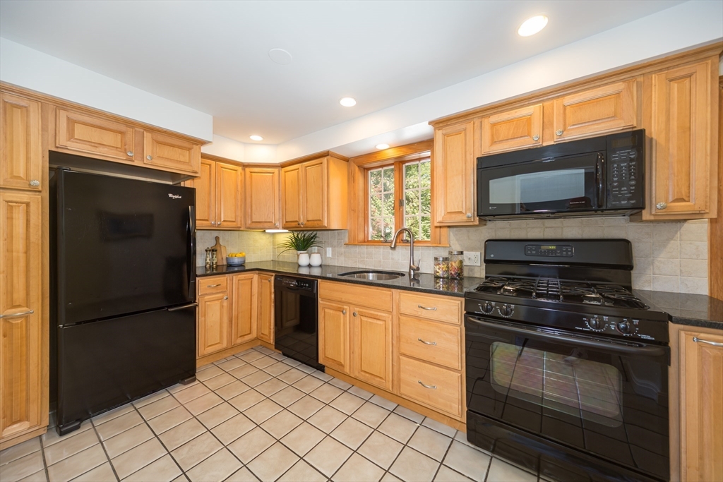 16 Surrey Lane Natick, MA 01760 - Photo 12 of 28 a kitchen with granite countertop a refrigerator stove top oven and sink