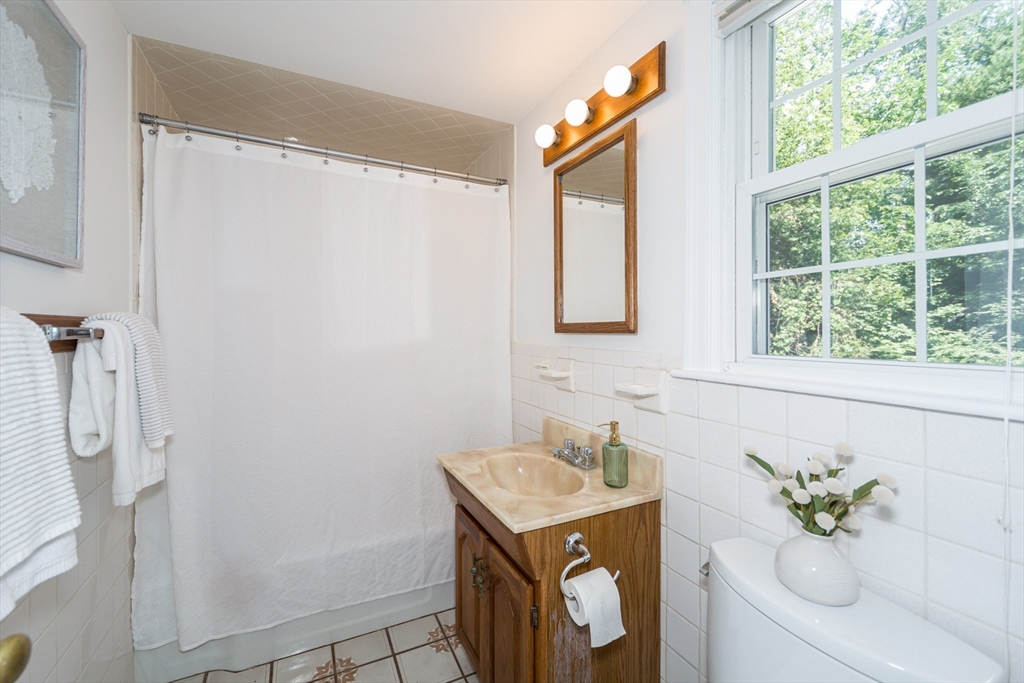 16 Surrey Lane Natick, MA 01760 - Photo 13 of 28 a bathroom with a sink toilet and tub