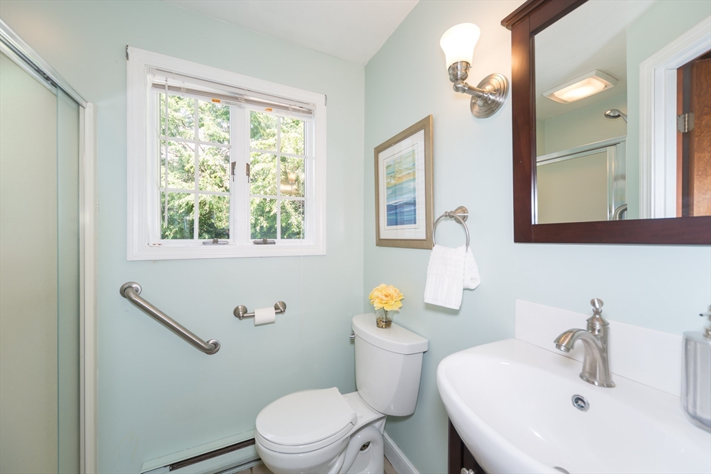 16 Surrey Lane Natick, MA 01760 - Photo 21 of 28 a bathroom with a sink mirror vanity and a toilet