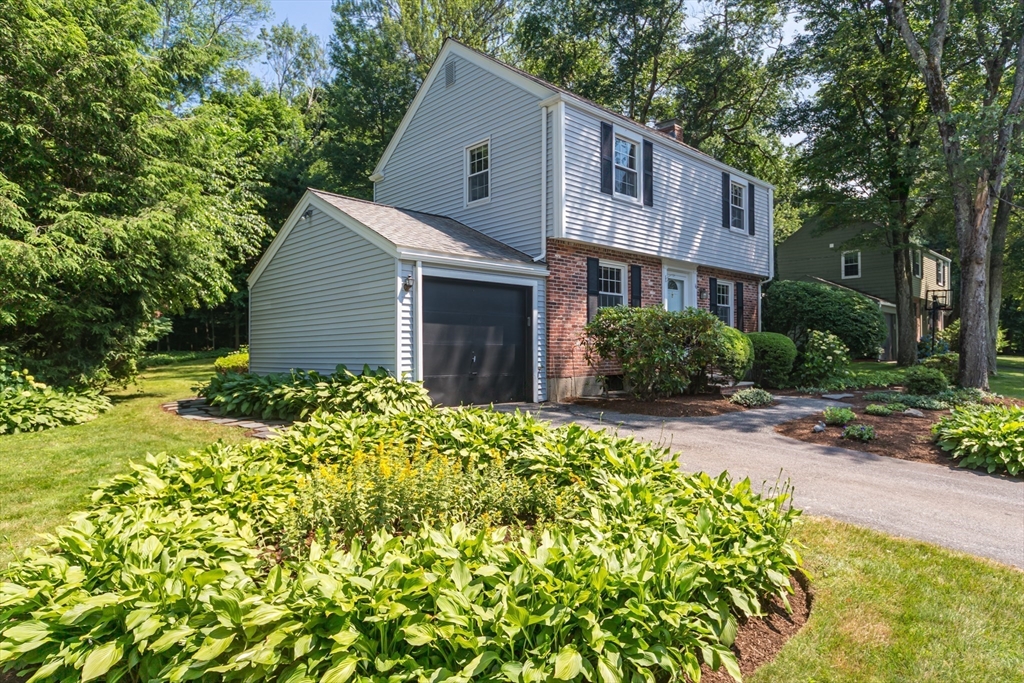 16 Surrey Lane Natick, MA 01760 - Photo 27 of 28 a view of a house with a yard and garden