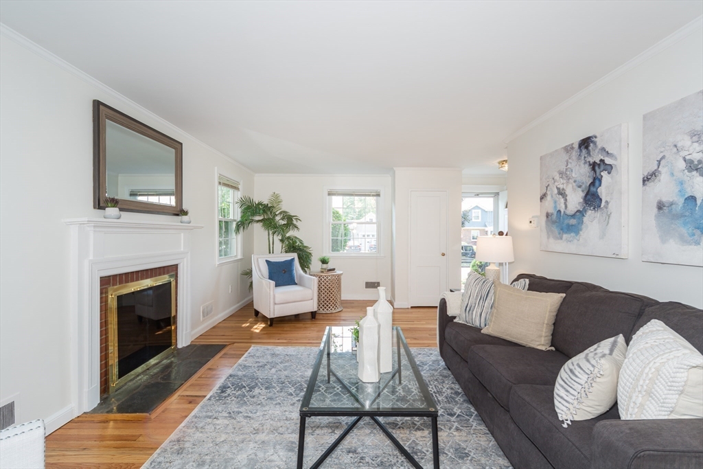 16 Surrey Lane Natick, MA 01760 - Photo 9 of 28 a living room with furniture a flat screen tv and a fireplace