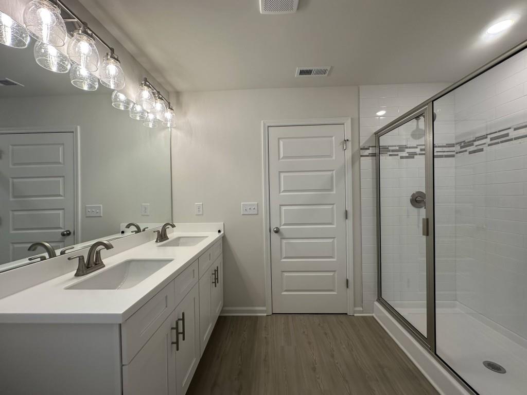 814 Glennferry Bend Southwest Mableton, GA 30126 - Photo 13 of 33 a bathroom with a double vanity sink mirror and shower