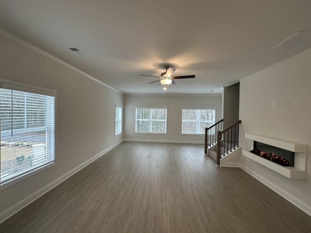 814 Glennferry Bend Southwest Mableton, GA 30126 - Photo 7 of 33 a view of a livingroom with wooden floor and a ceiling fan