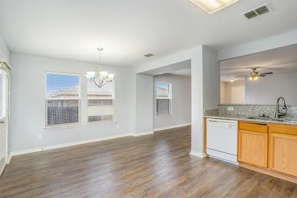 a view of a kitchen with granite countertop wooden floor and a sink