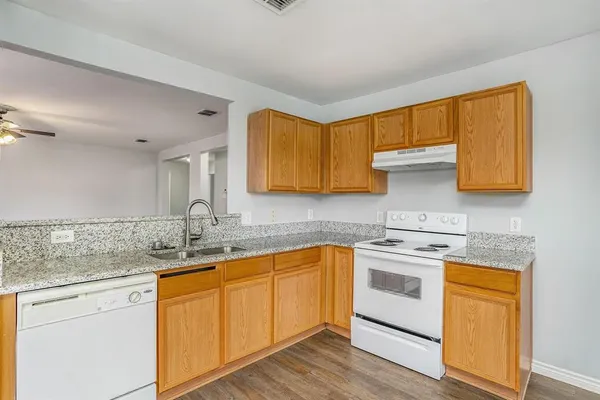 a kitchen with stainless steel appliances granite countertop a sink stove and cabinets