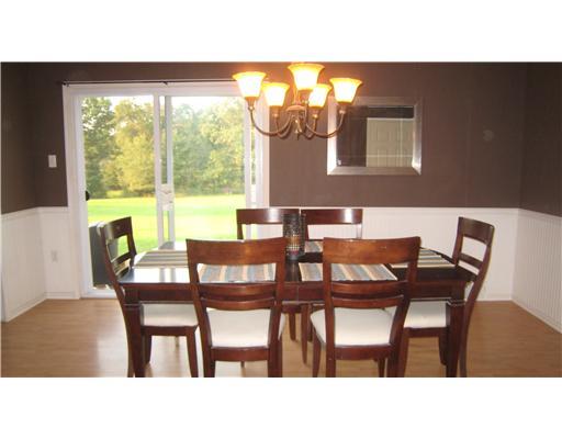 152 Winterset Road Economy, PA 15005 - Photo 4 of 18 Dining Room. Dining room has wainscoting, updated chandelier, laminate flooring and sliding doors to gigantic backyard.
