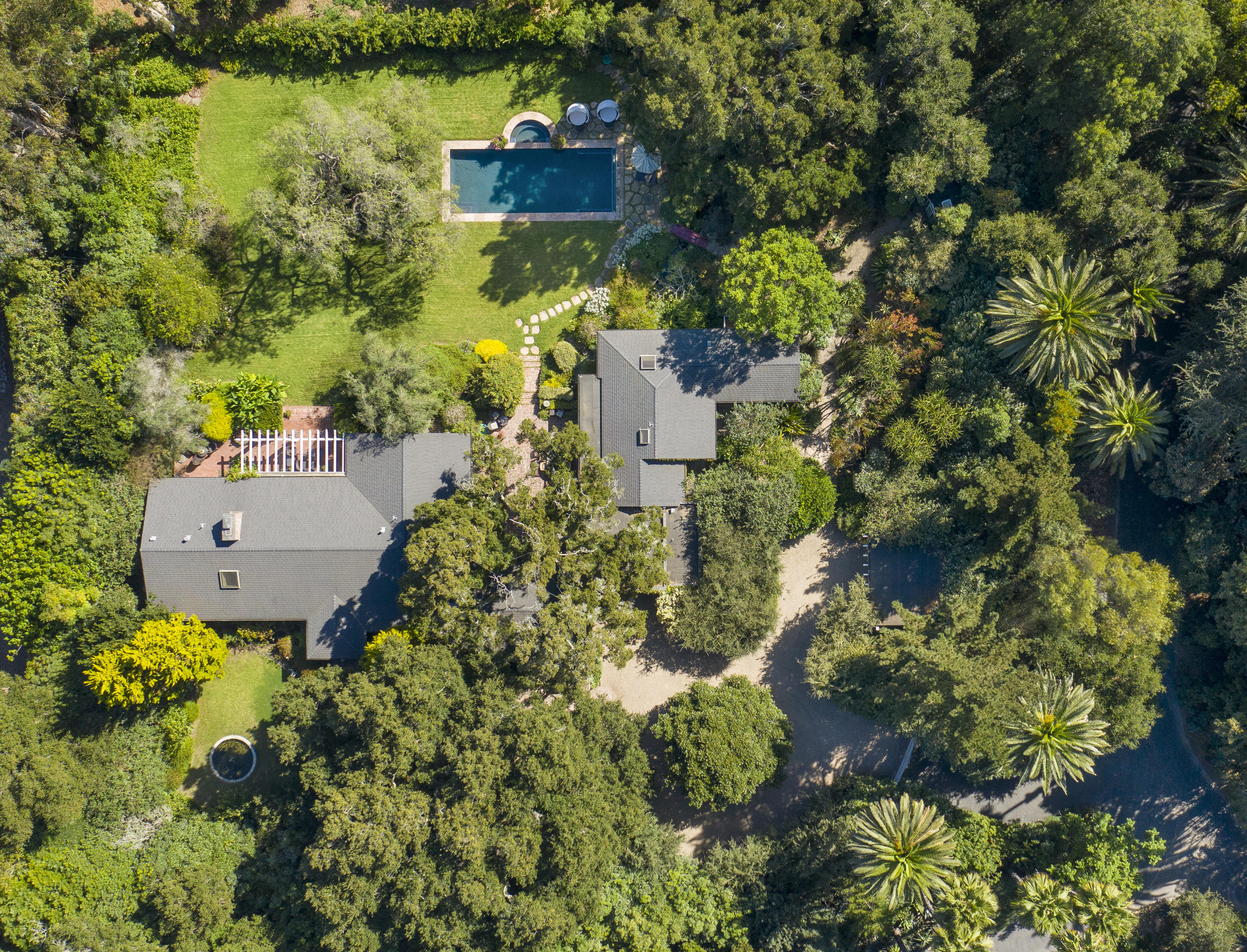 1422 East Valley Road Santa Barbara, CA 93108 - Photo 3 of 25 a picture of a yard with plants and large trees
