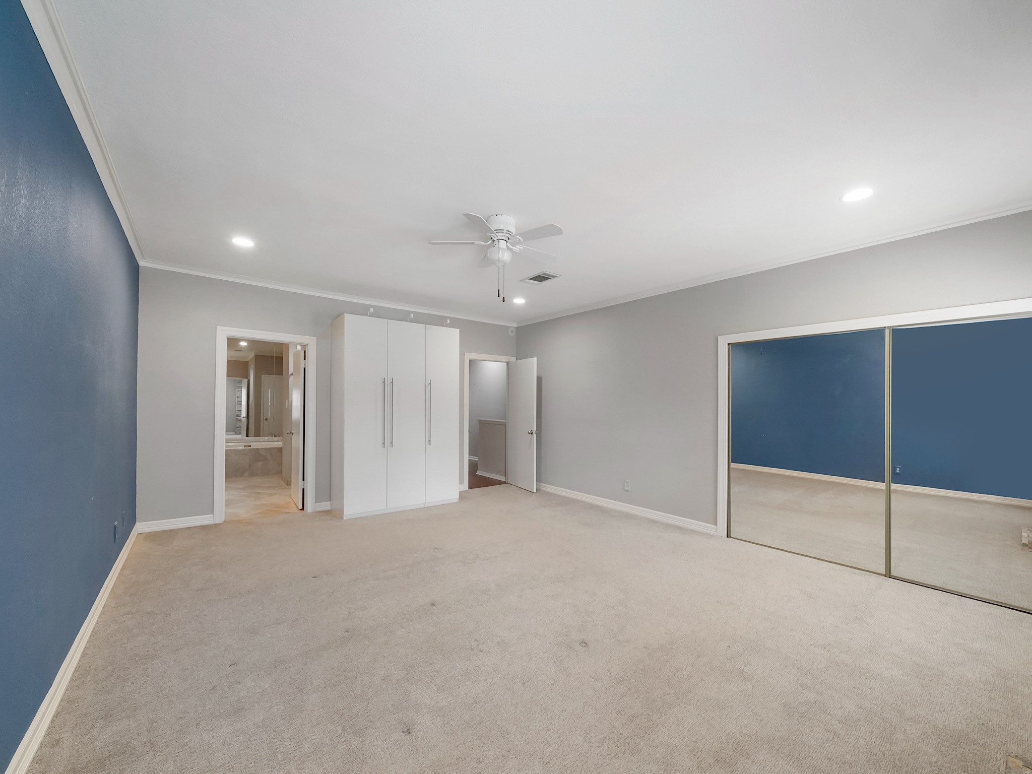 6000 Reims Road, Unit 2205 Houston, TX 77036 - Photo 17 of 35 Primary suite closet enhanced with sleek mirrored doors and floor to ceiling built-in wardrobe included.