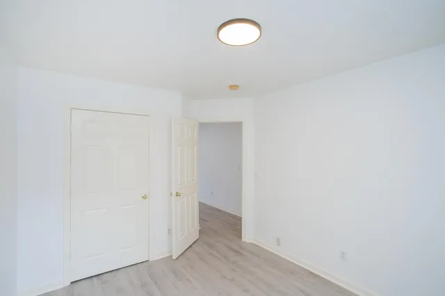 a view of a room with wooden floor