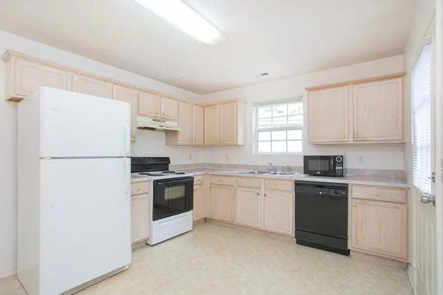 a kitchen with a sink stove and refrigerator